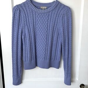 Cable knit crew neck sweater.